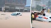 Brusttief im Hochwasser: Anwohner retten Autoinsassen in China